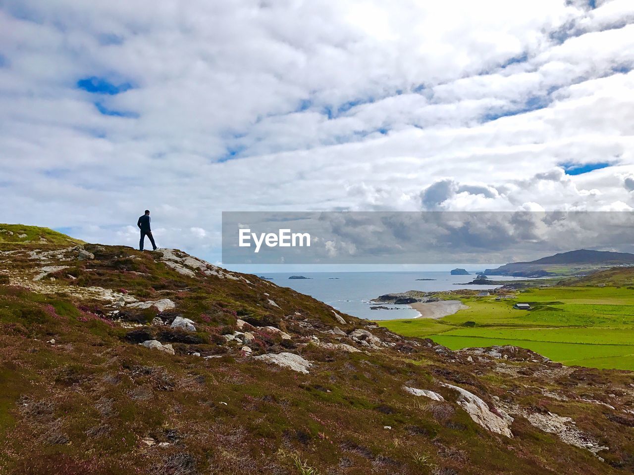 Man standing on mountain against sky