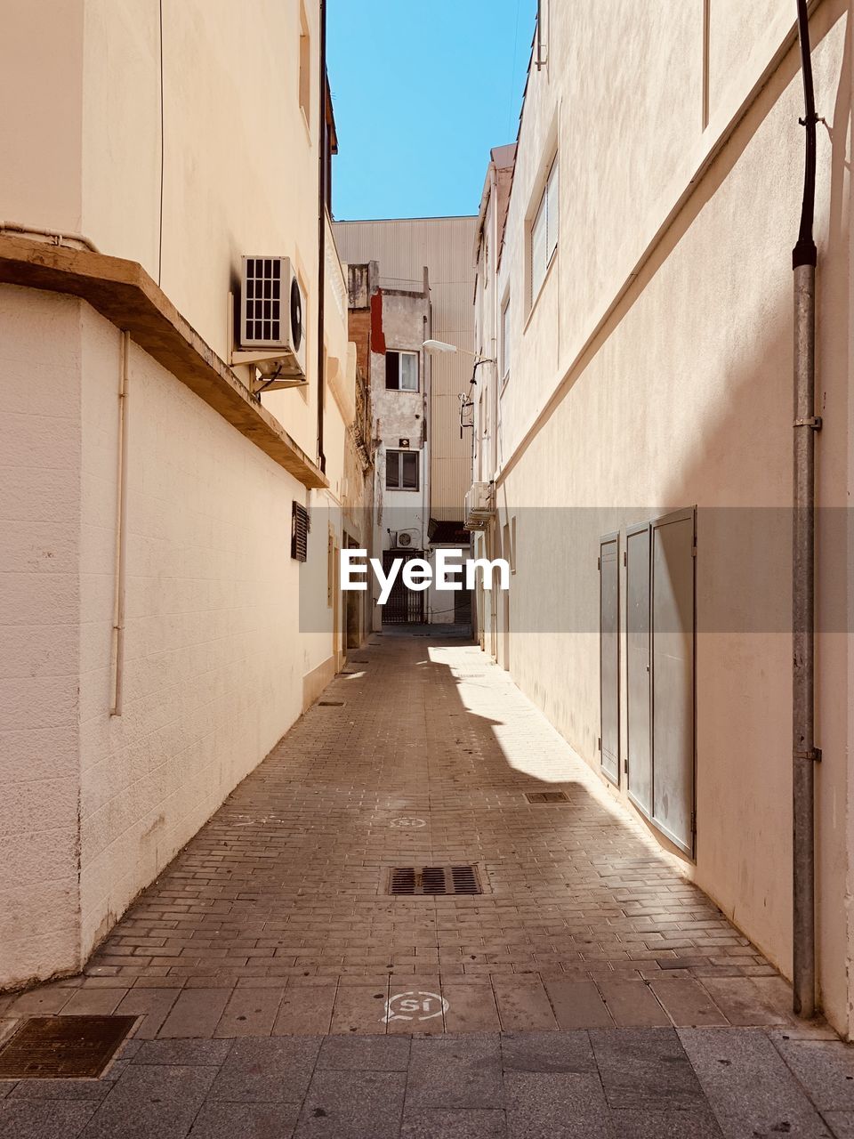 Empty alley amidst buildings in city