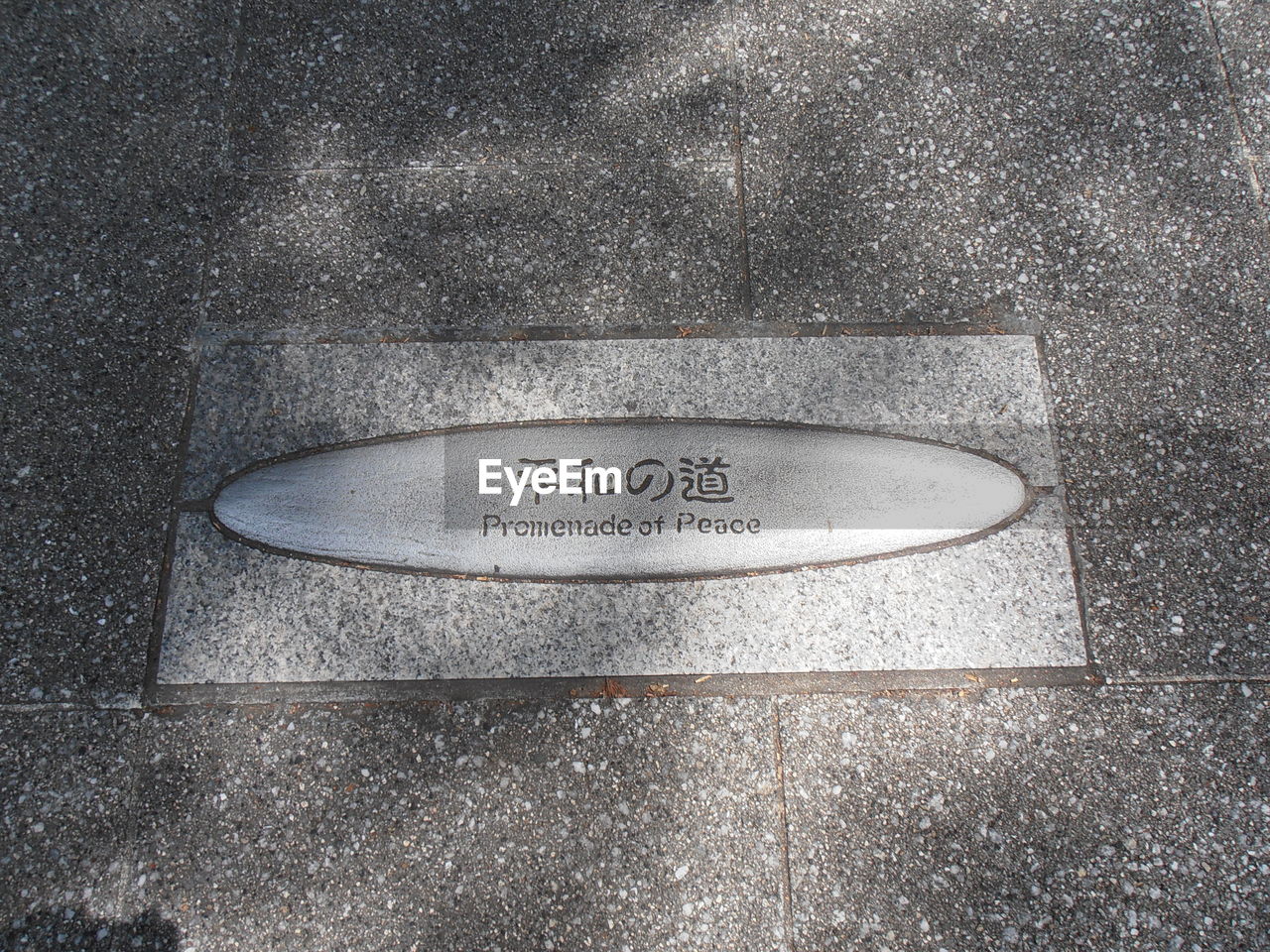 HIGH ANGLE VIEW OF TEXT ON CONCRETE