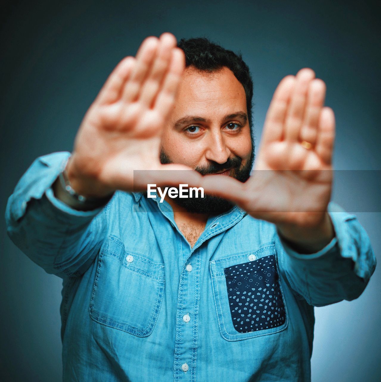 Close-up portrait of a man gesturing