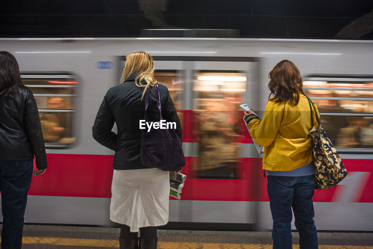 Women standing at railroad station platform