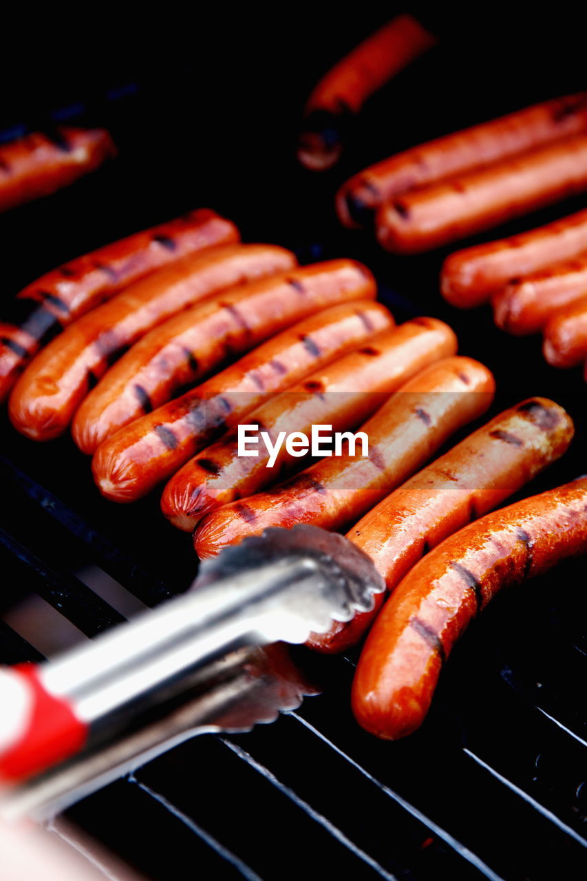 Close-up of hot dogs on barbecue grill