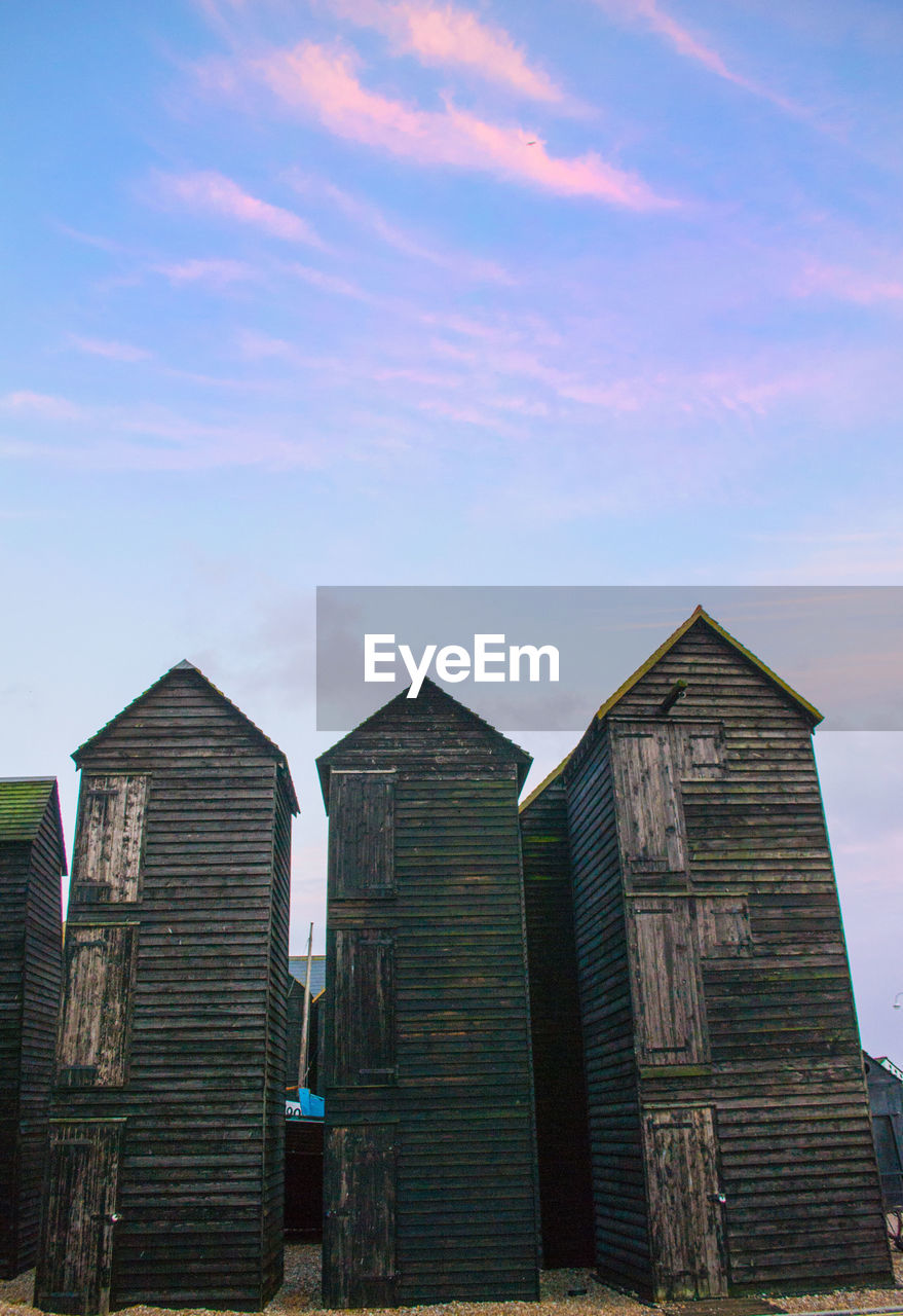 LOW ANGLE VIEW OF BUILDINGS AGAINST BLUE SKY