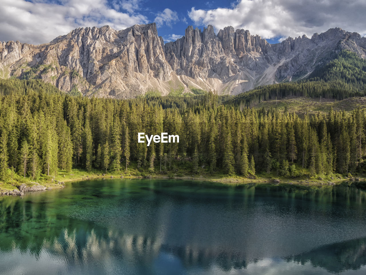 Scenic view of alpine lake and mountains against sky in dolomites region