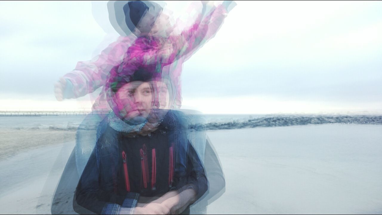 Multiple exposure of father carrying daughter on shoulders