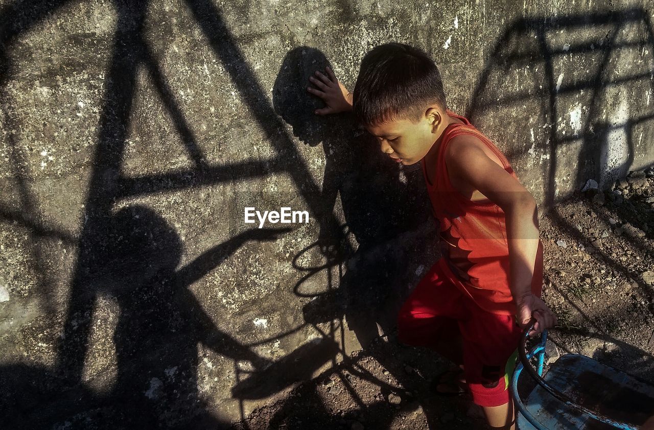 GIRL STANDING WITH SHADOW OF PEOPLE