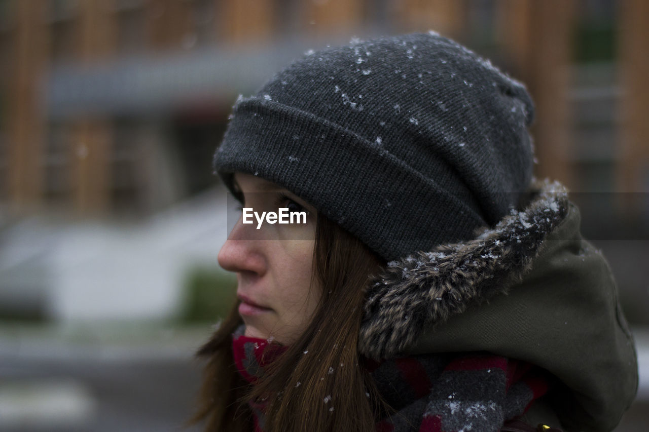 Close-up of woman looking away during winter