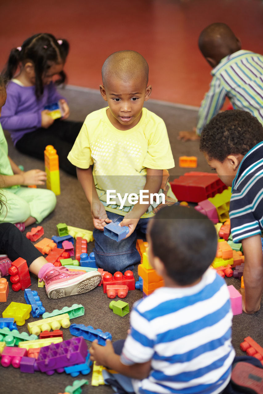 high angle view of boy playing with toys on table