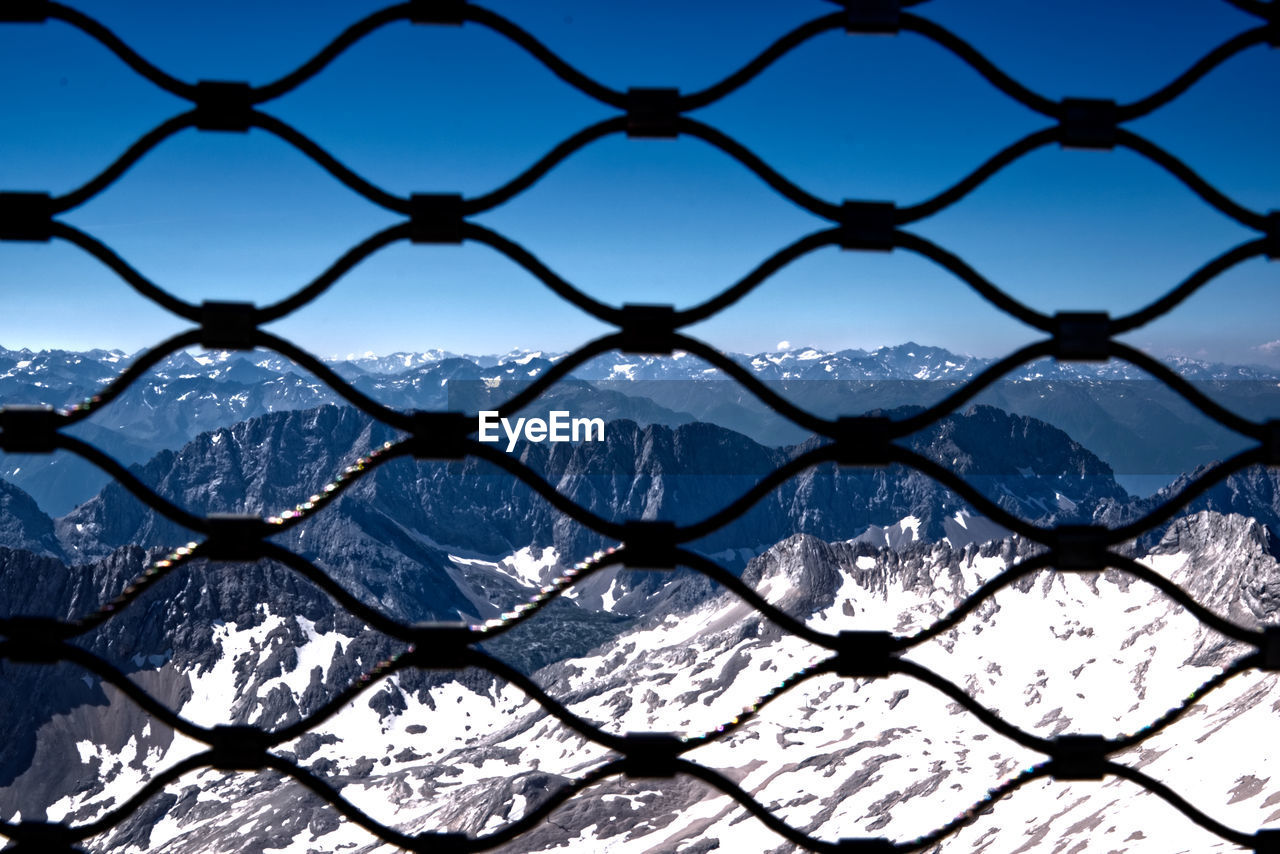 CLOSE-UP OF CHAINLINK FENCE DURING WINTER