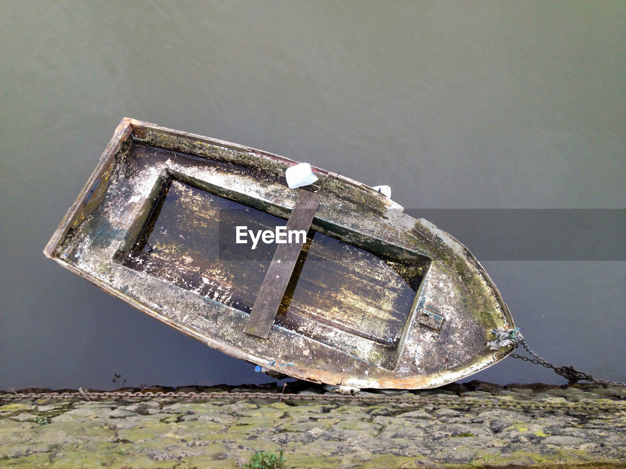 Directly above shot of damaged boat moored on river