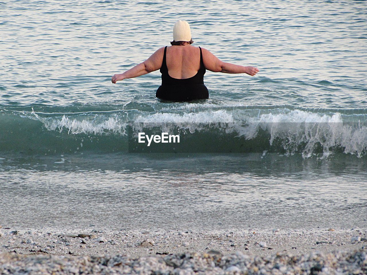 Rear view of woman in sea