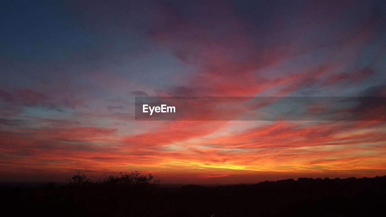 Scenic view of dramatic sky during sunset