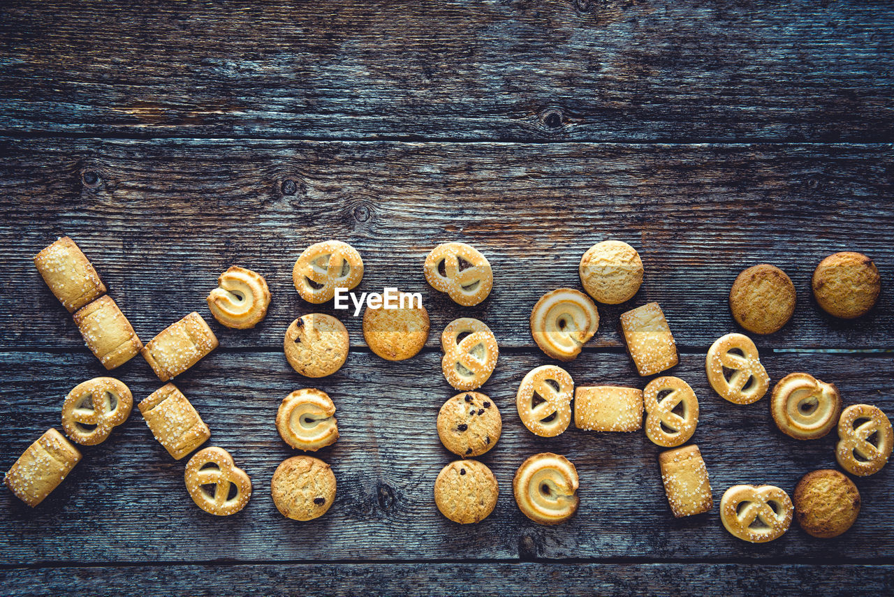 Xmas word made from gingerbread cookies on a wooden background. christmas background