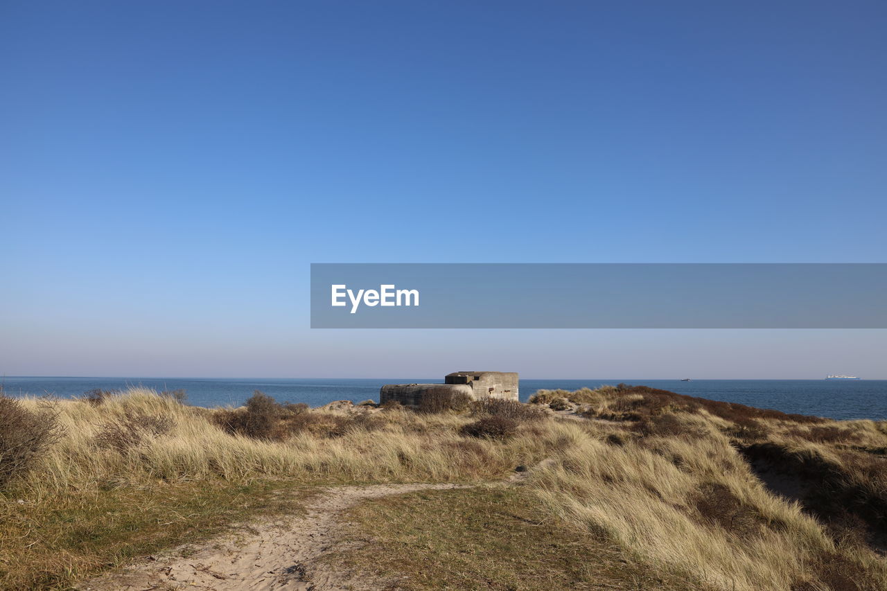 Scenic view of sea against clear blue sky