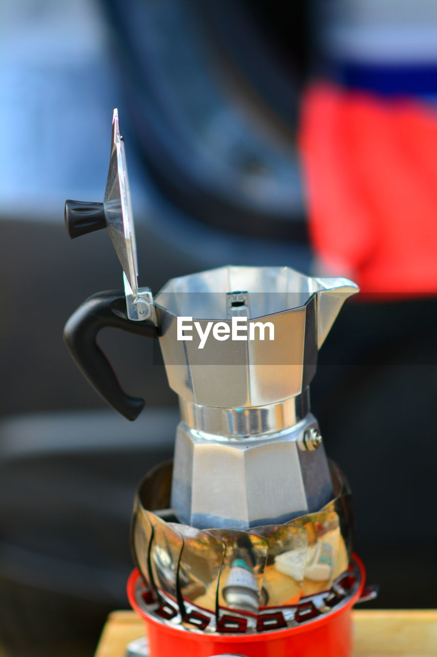 CLOSE-UP OF COFFEE CUP ON TABLE AT HOME