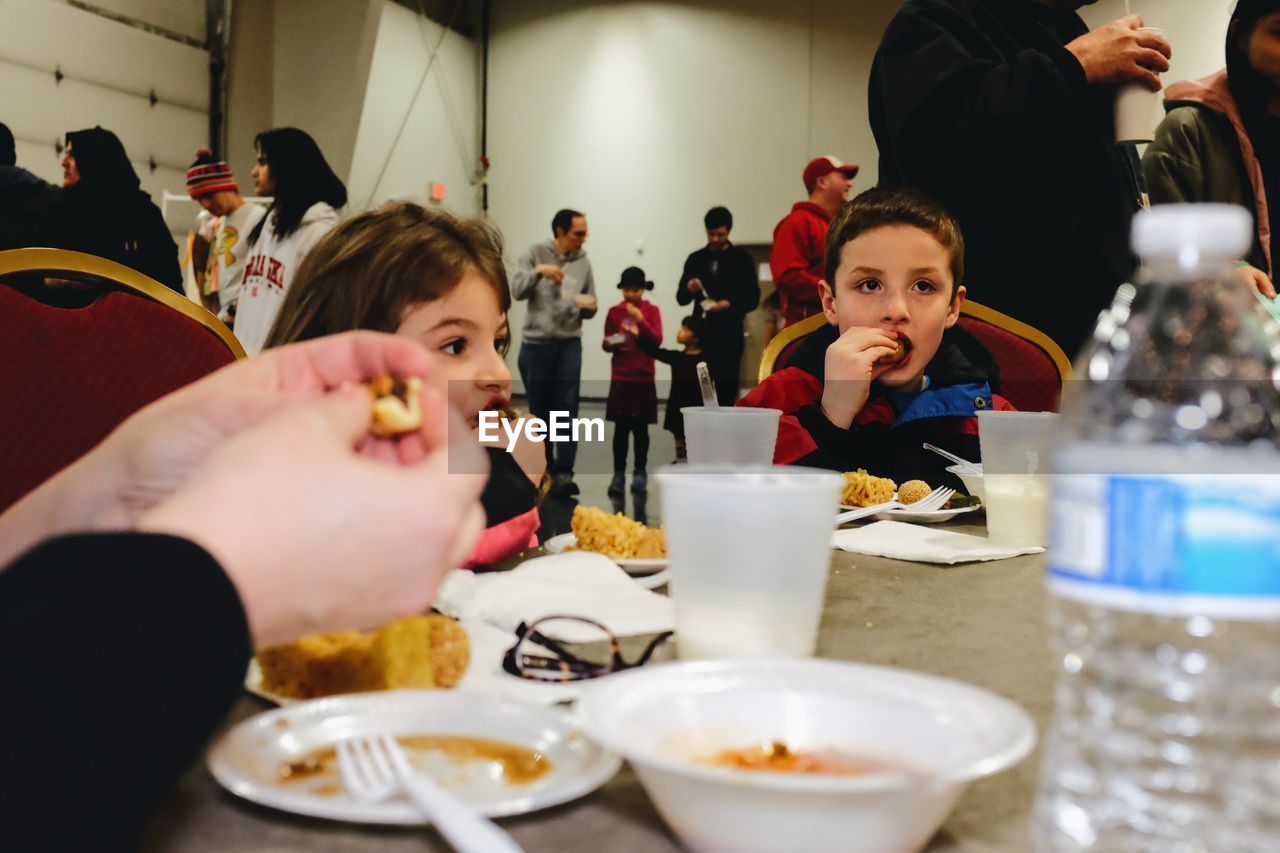 Family having food at table in restaurant