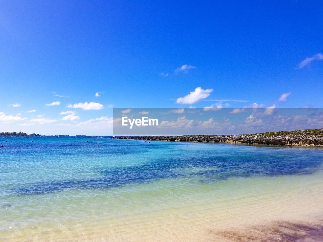 Scenic view of sea against blue sky