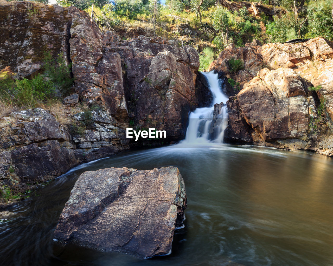 Waterfall amidst rock formation in forest