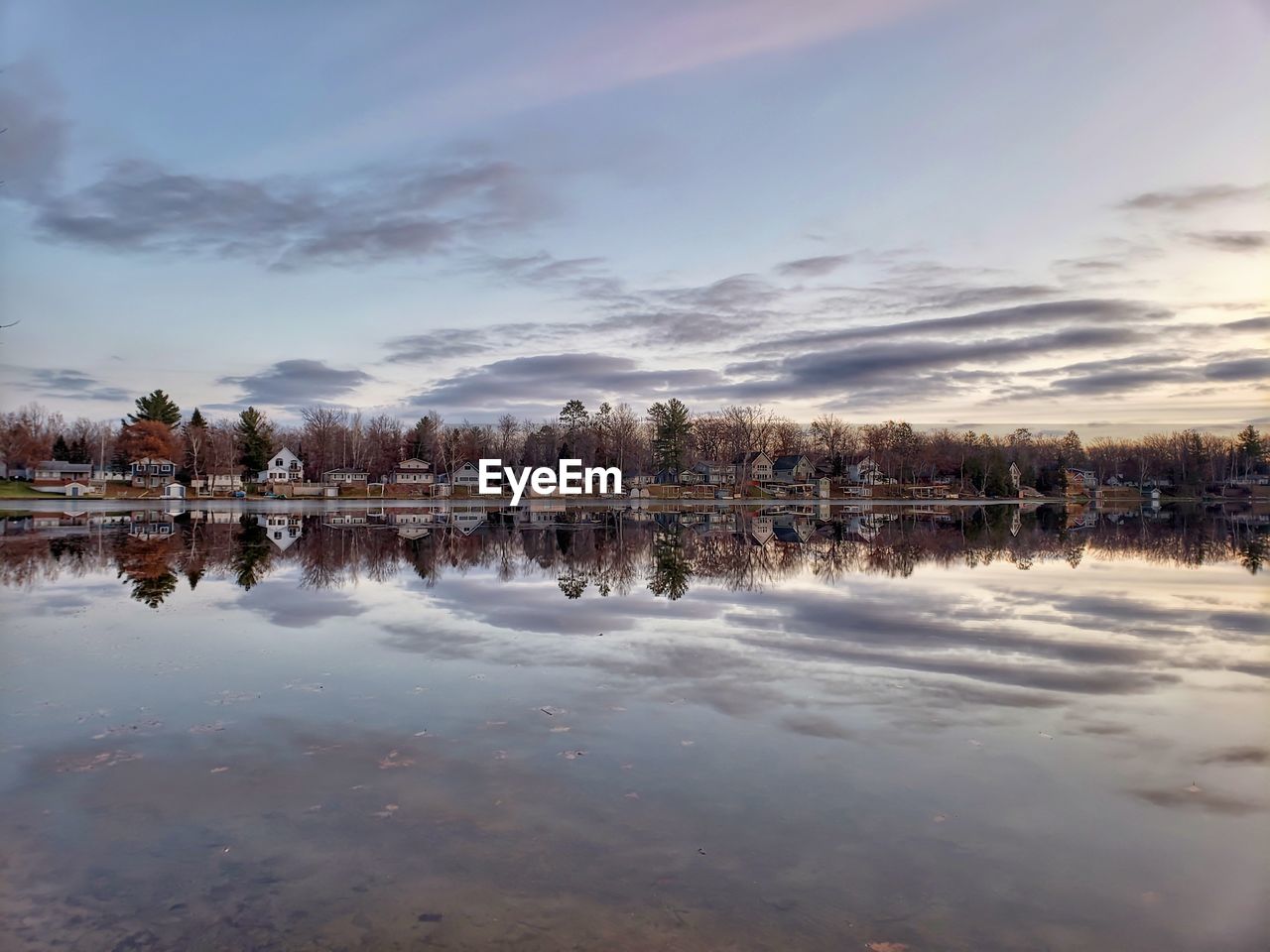 Scenic view of lake against sky at sunset