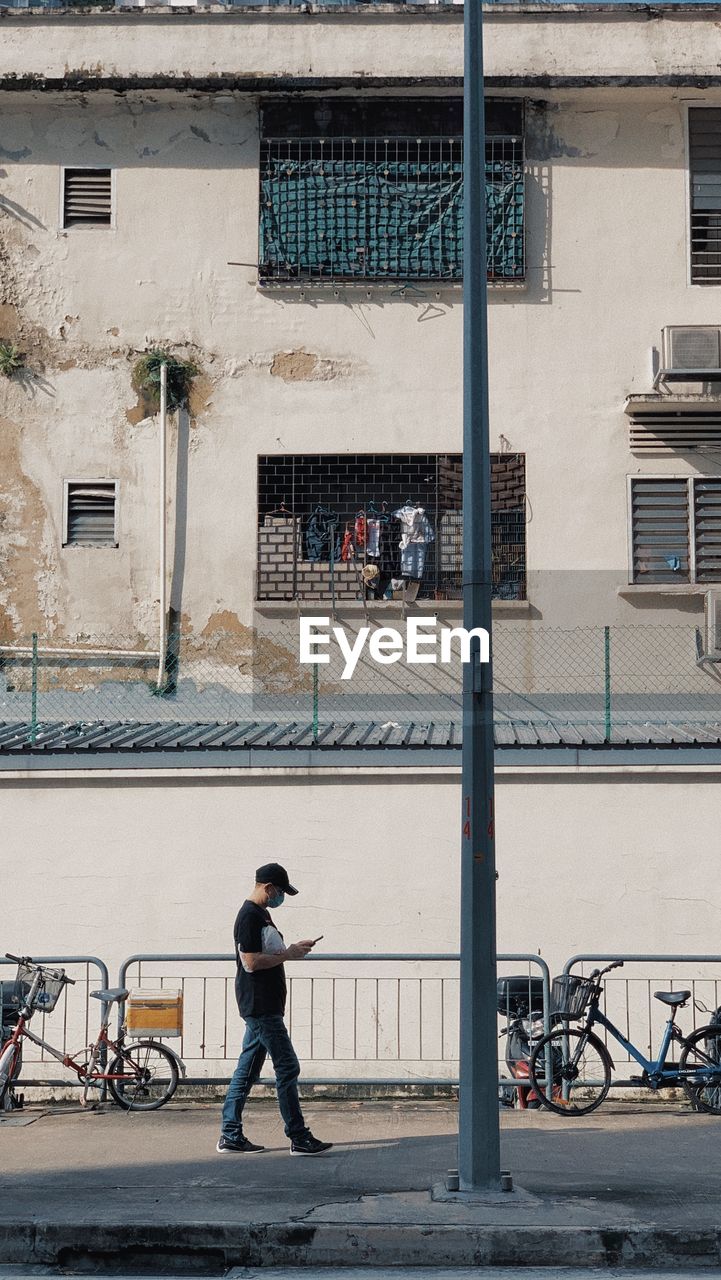 Low angle view of man walking on street