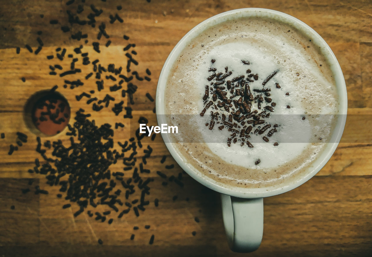 HIGH ANGLE VIEW OF COFFEE CUP ON TABLE WITH SPOON