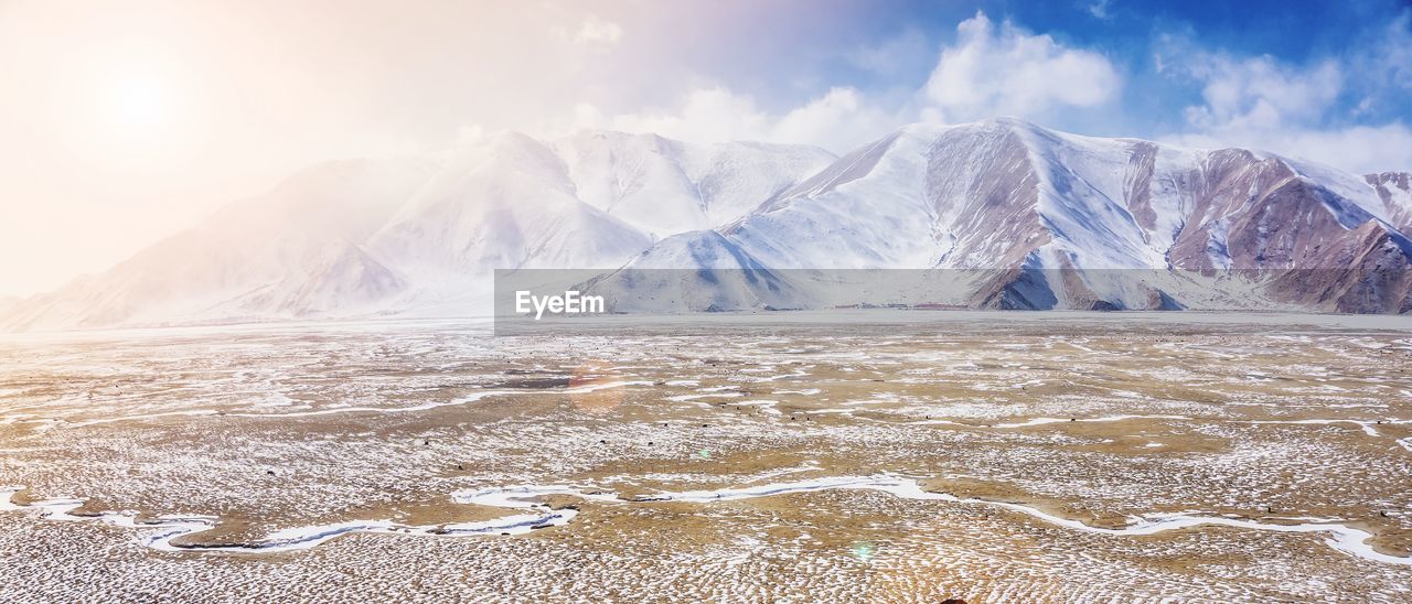 Scenic view of snowcapped mountains against sky