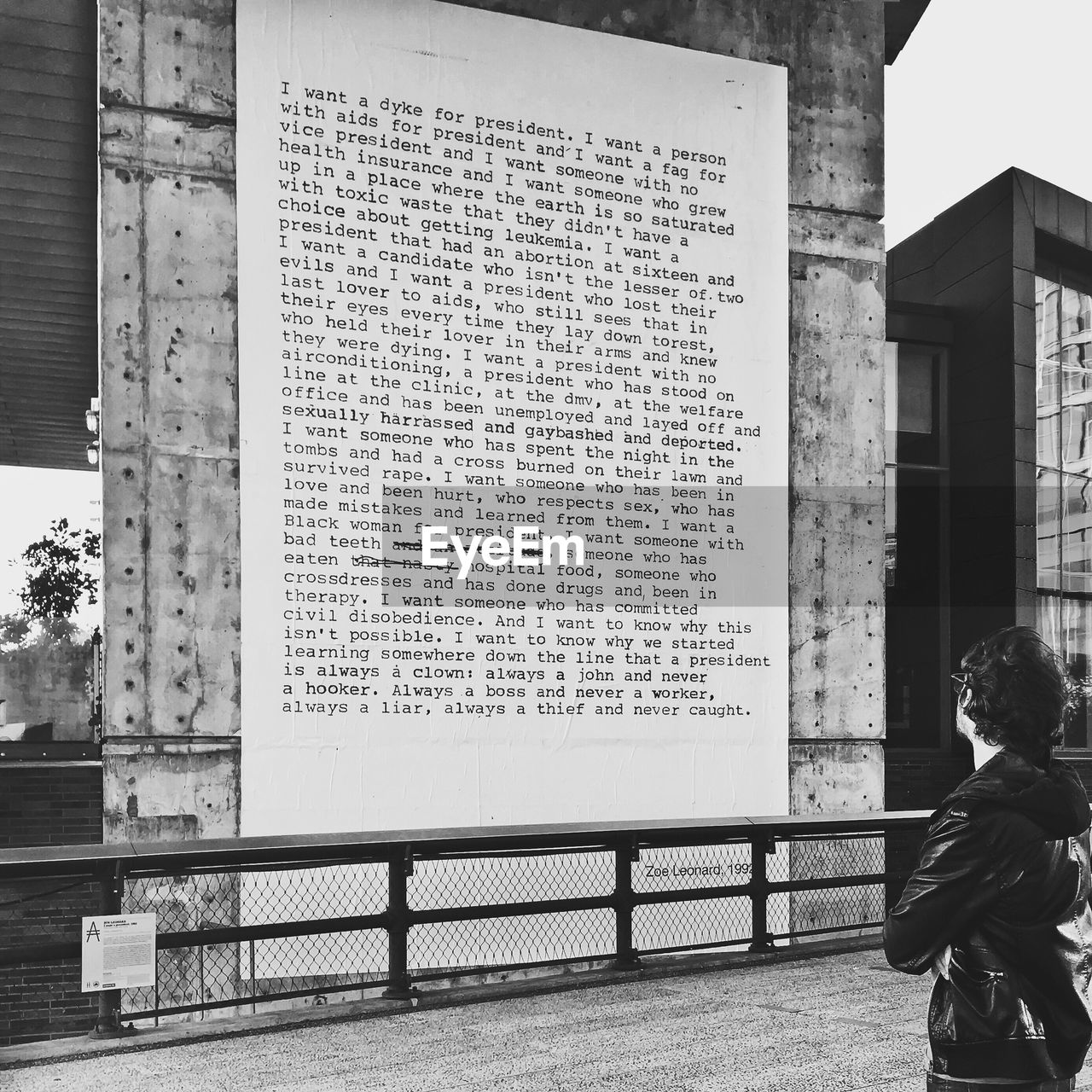 MIDSECTION OF MAN WITH TEXT ON BUILDING