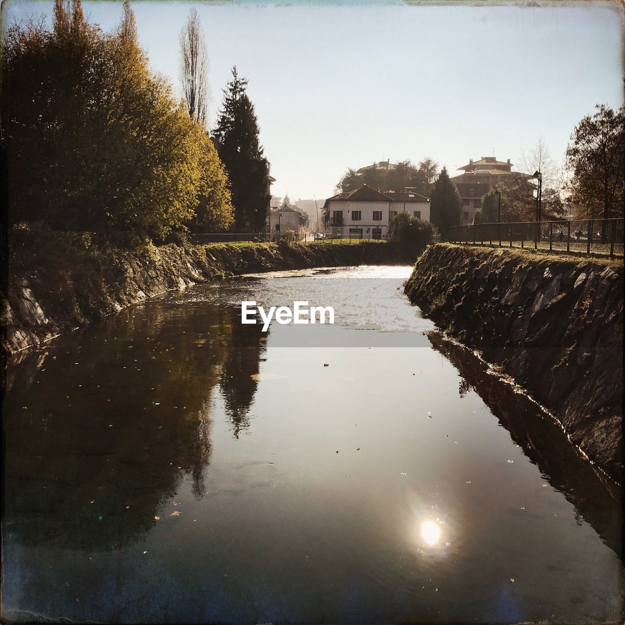 Reflection of houses and trees in water