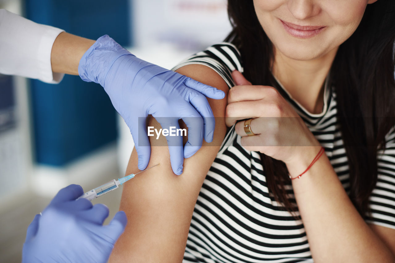 Woman receiving an injection in her arm