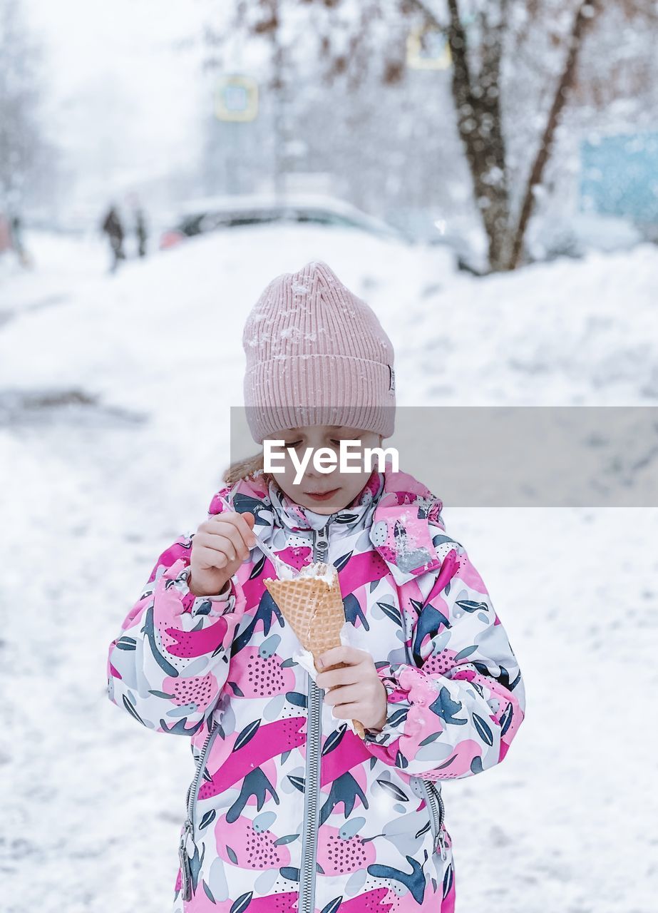 Portrait of girl standing on snow