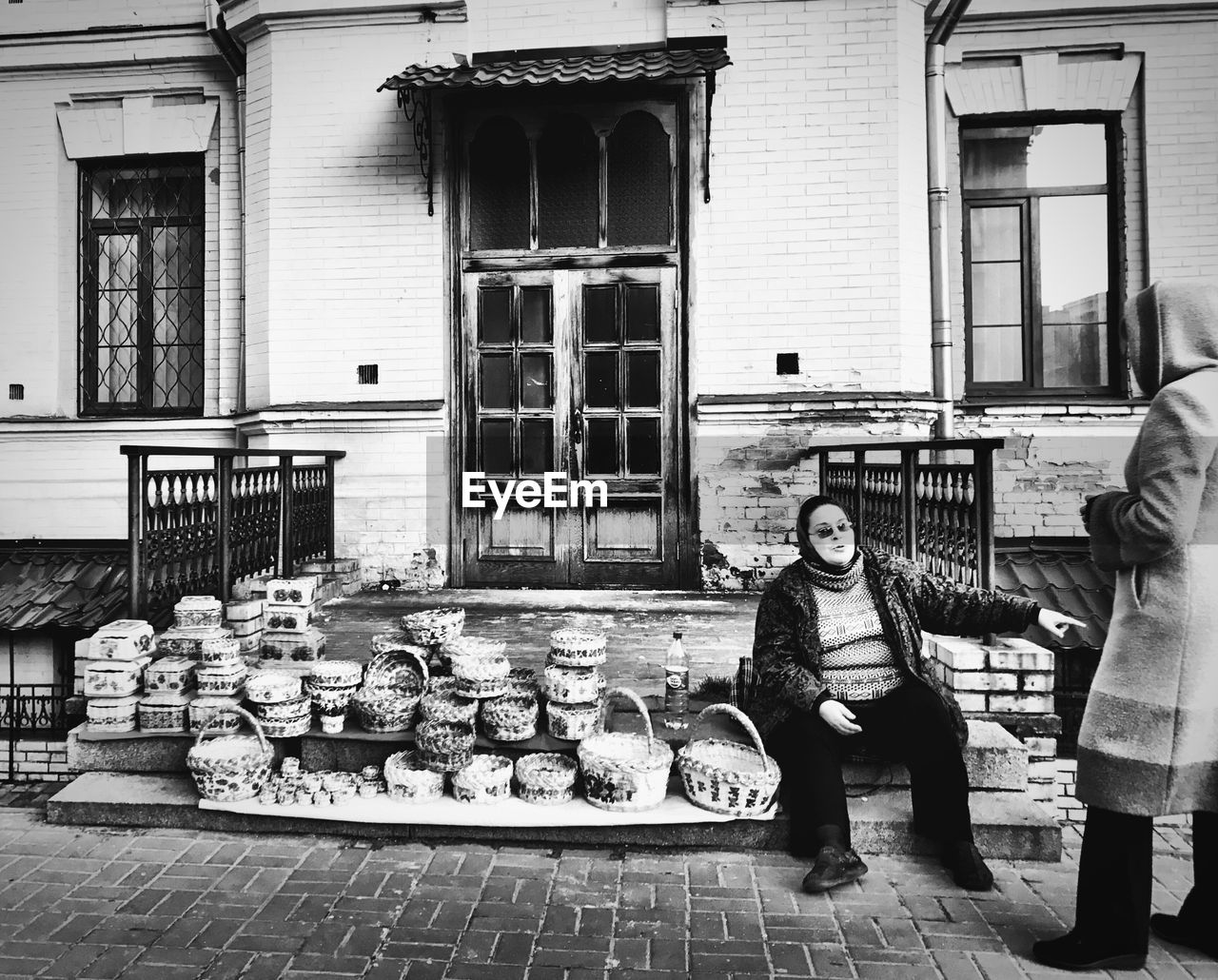 FULL LENGTH OF WOMAN STANDING BY BUILDING