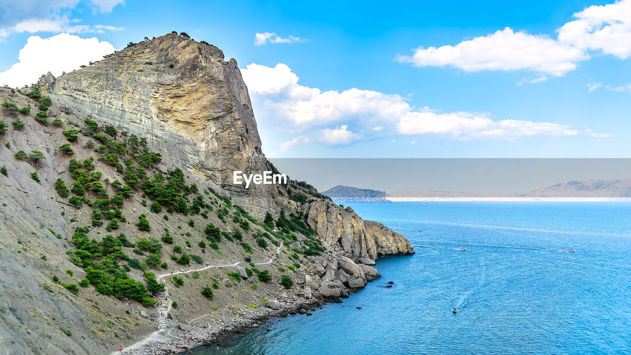 SCENIC VIEW OF SEA AND ROCK FORMATION AGAINST SKY