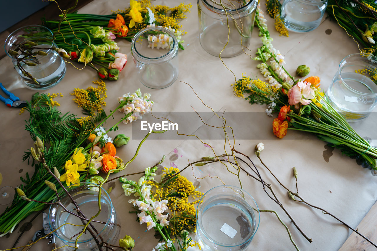 Top view on the table with bouquets at flower workshop