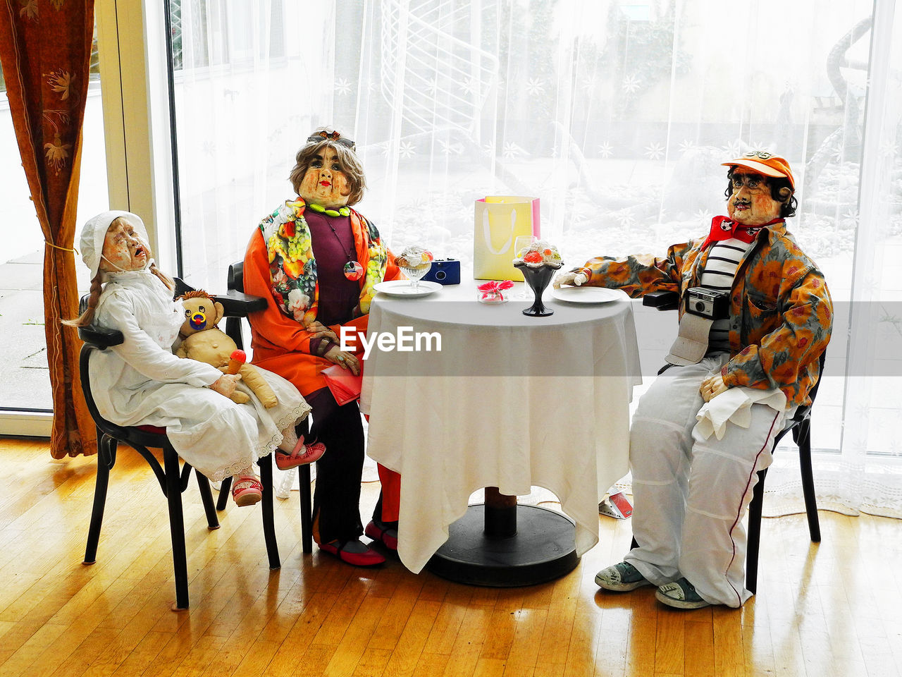 GROUP OF PEOPLE SITTING ON TABLE