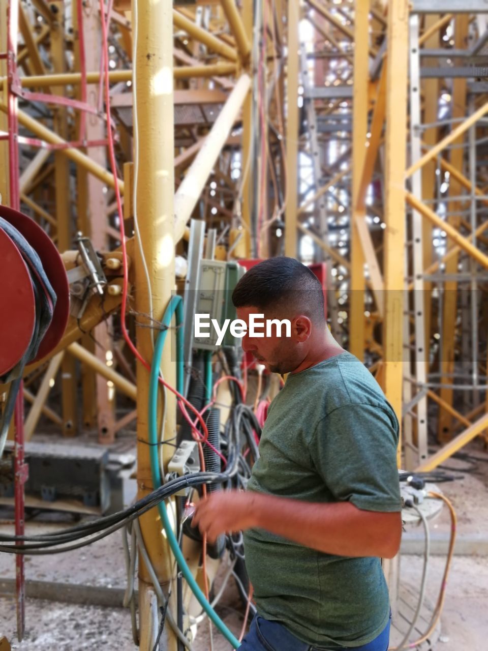 SIDE VIEW OF A MAN WORKING IN TRADITIONAL WINDMILL