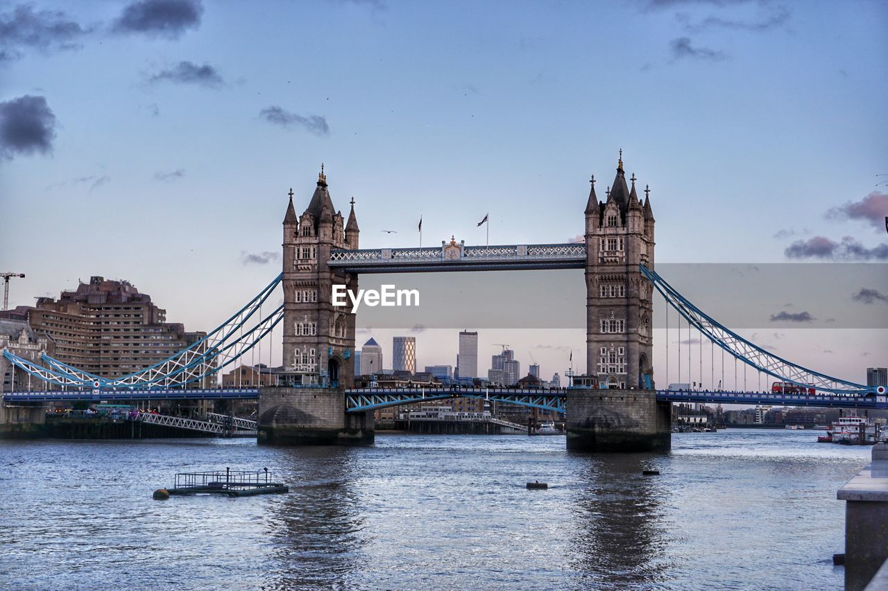 Bridge over river with city in background