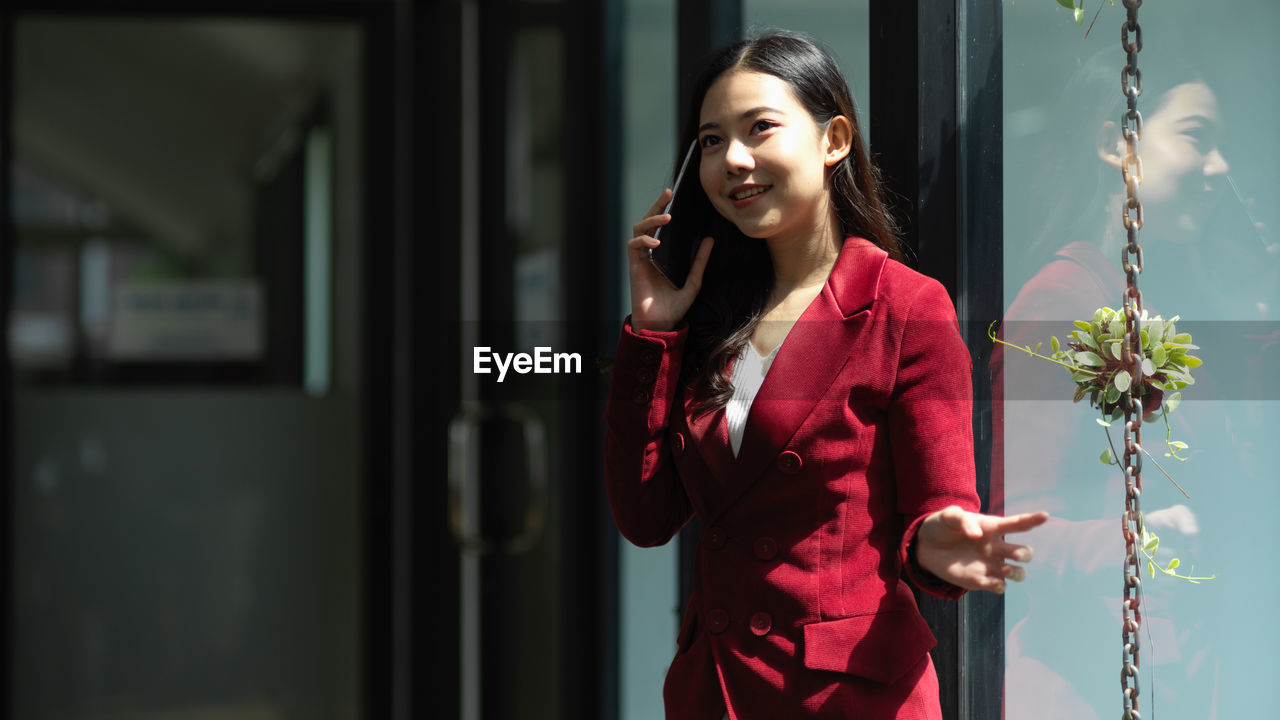 Young businesswoman talking on phone at office