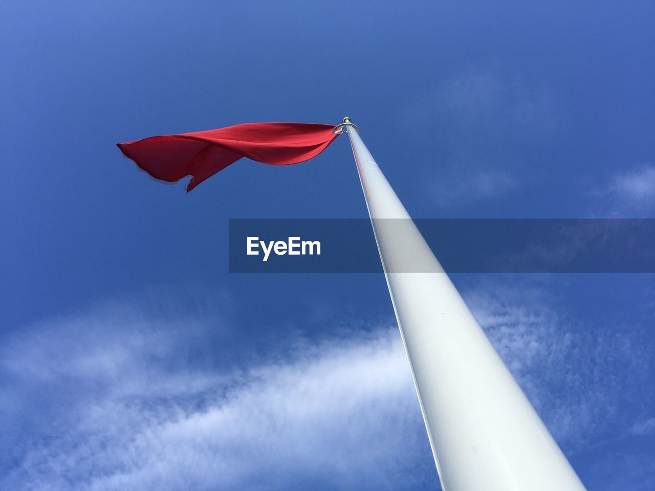 Low angle view of danger flag against sky