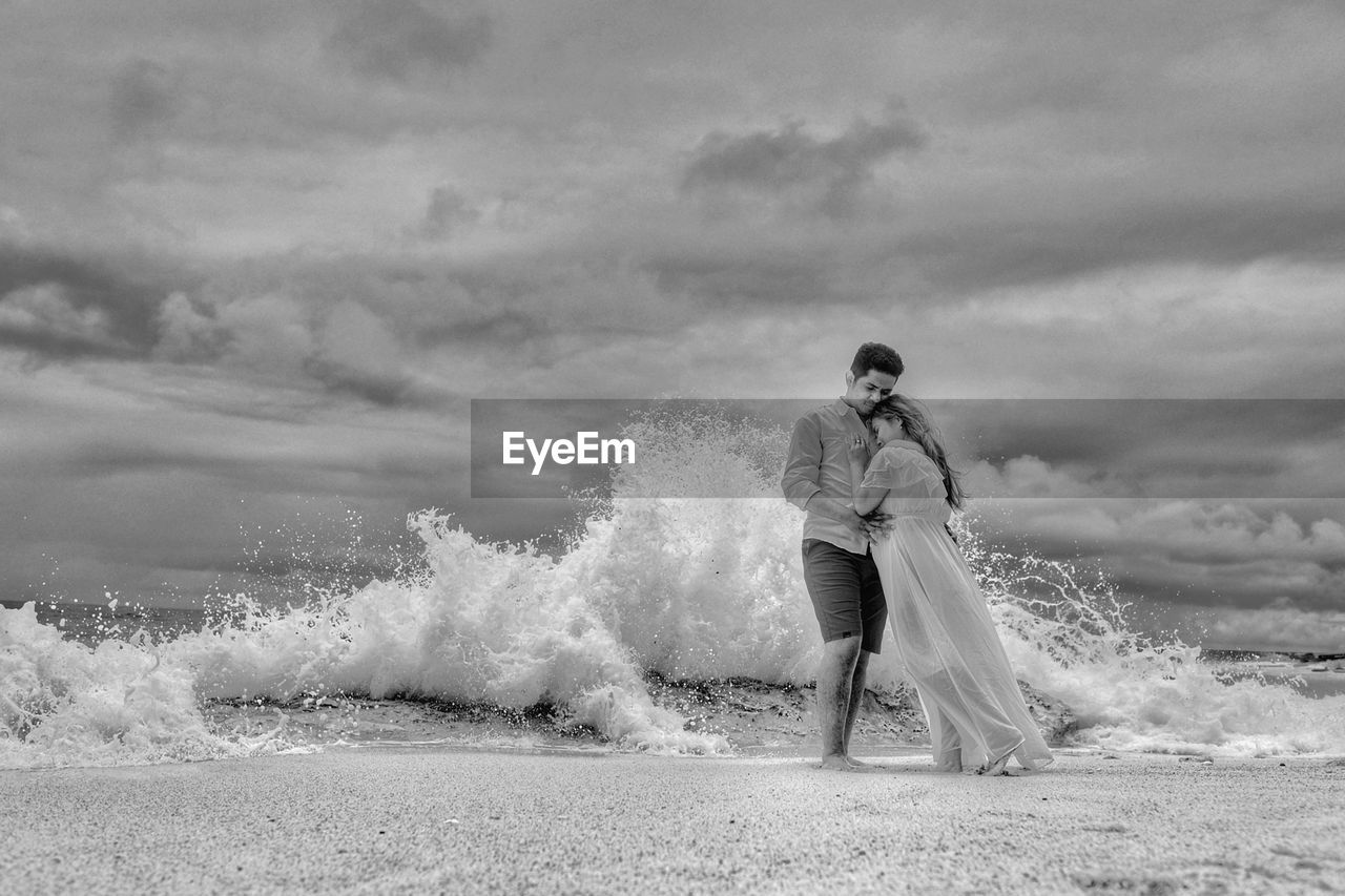 wedding dress, bride, black and white, adult, land, full length, beach, nature, women, monochrome photography, sky, cloud, sea, water, young adult, monochrome, men, emotion, wedding, white, sand, positive emotion, love, one person, motion, clothing, female, newlywed, beauty in nature, lifestyles, standing, person, outdoors, event, wave, environment, day, life events, celebration, leisure activity, dress