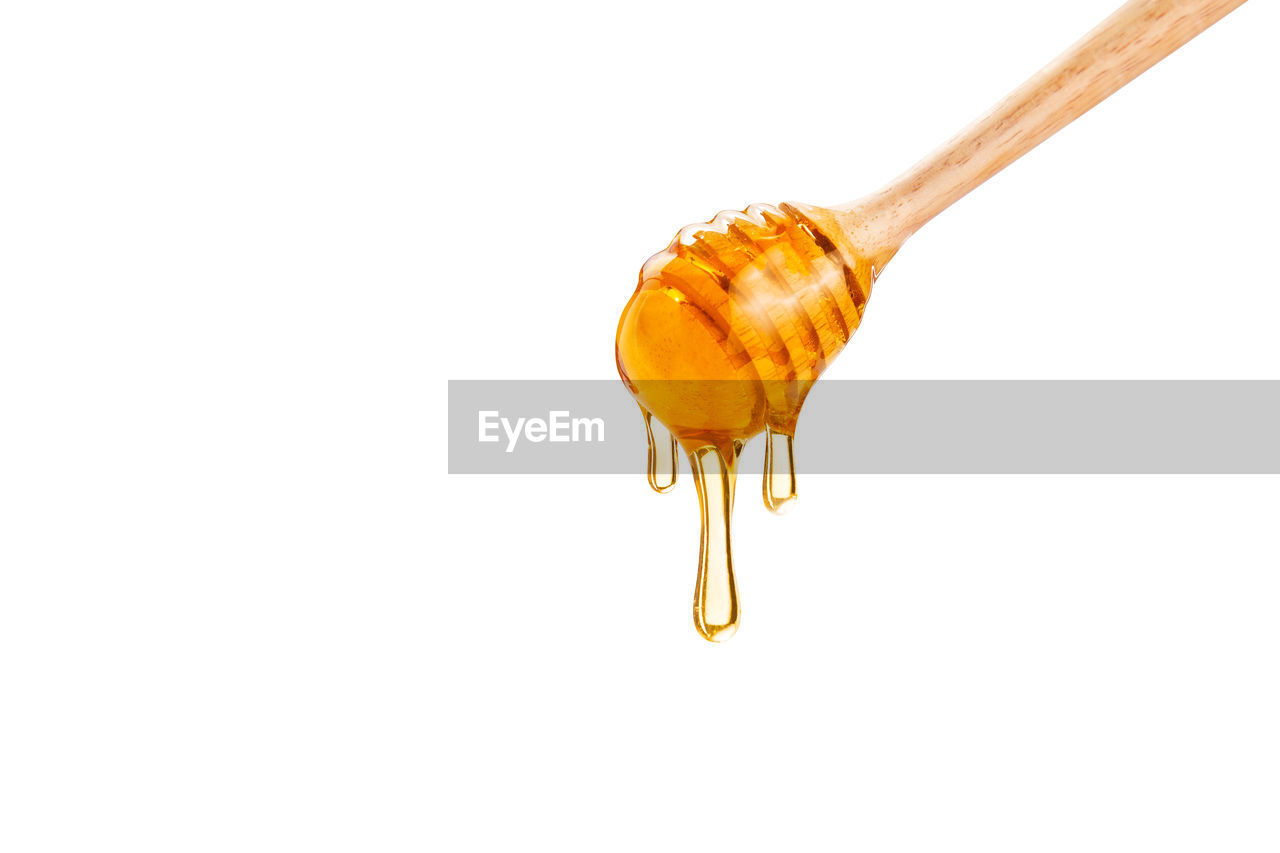 Honey dripping down from honey dipper