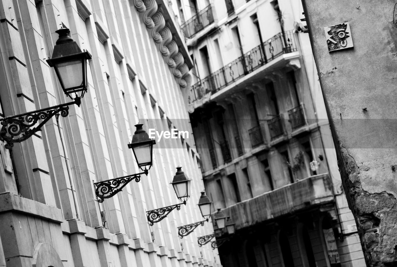 Low angle view of lamps on old building