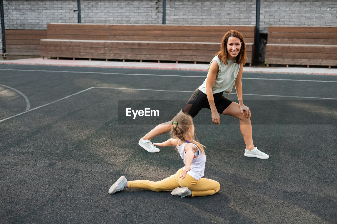 Full length of woman exercising in gym