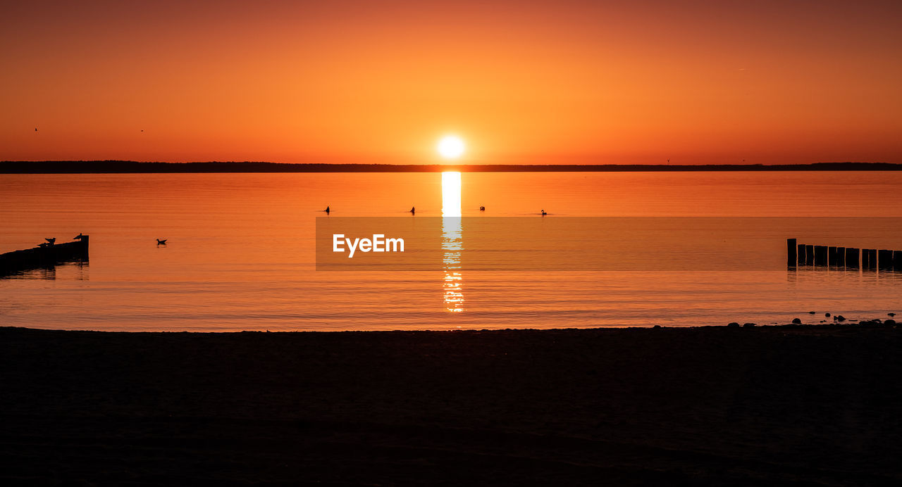 Scenic view of sea against sky at sunset