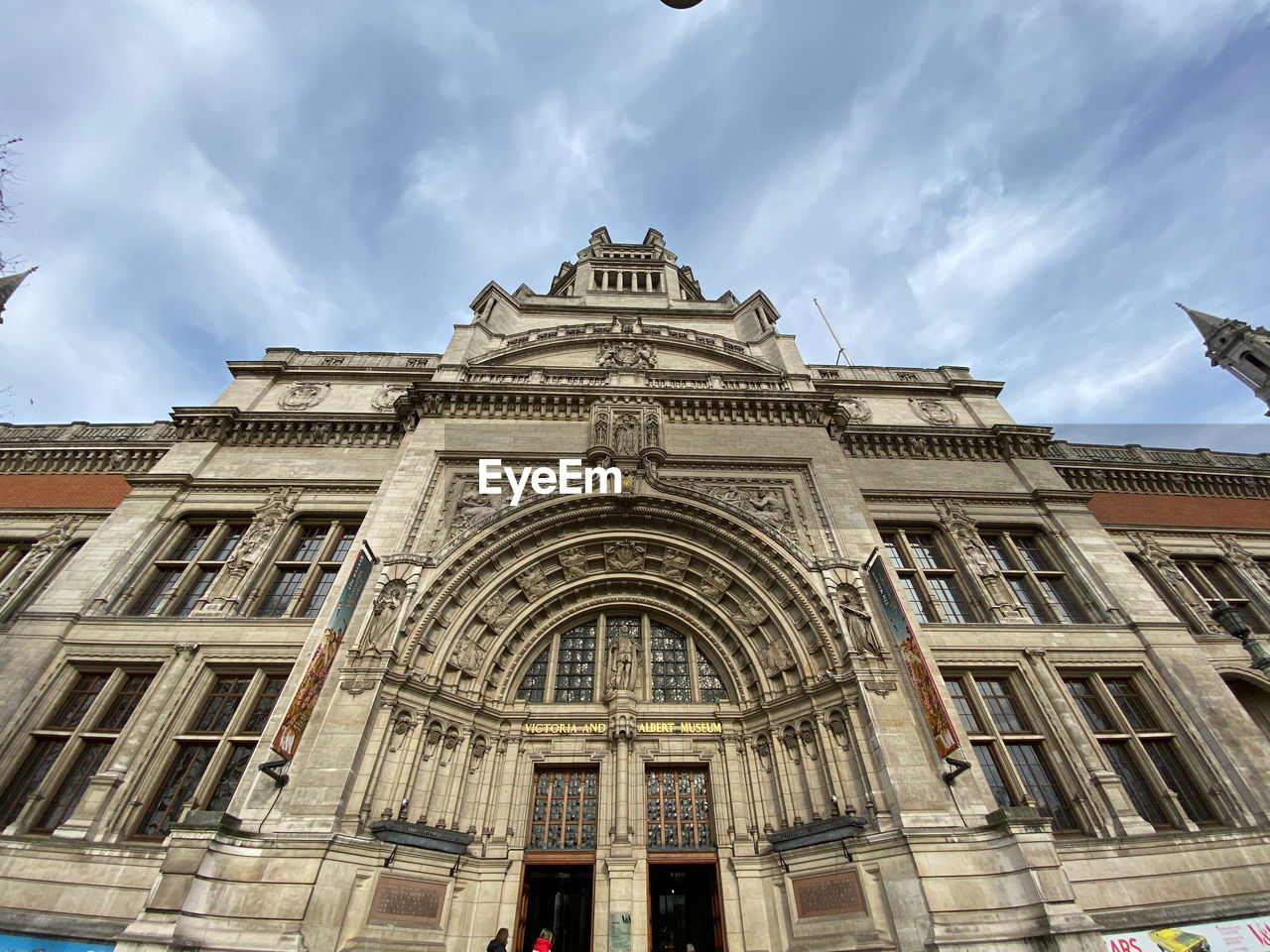 Low angle view of victoria and albert miseum building against cloudy sky