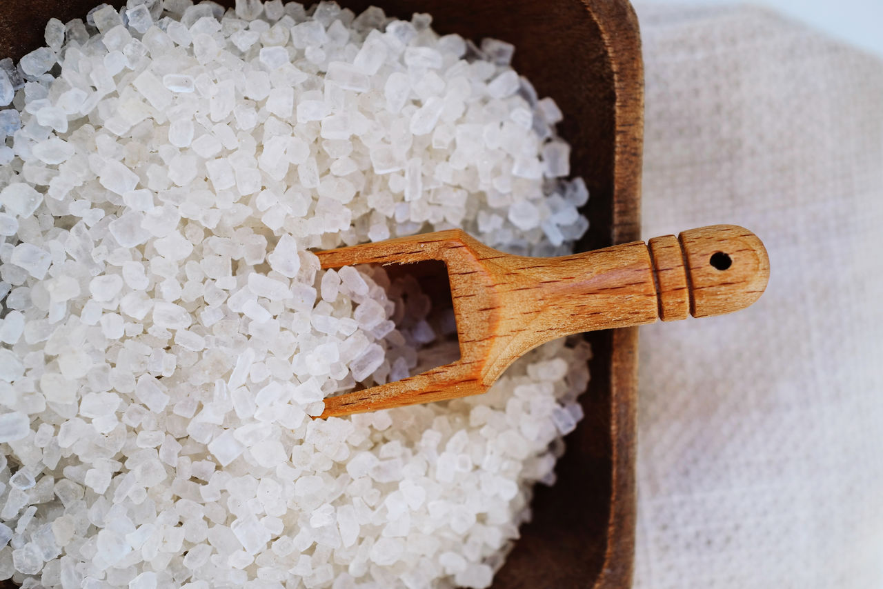 Coarse salt on the wooden bowl