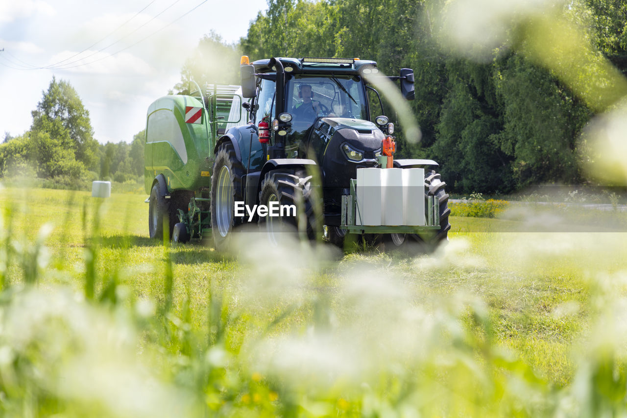 Tractor working in field on sunny day