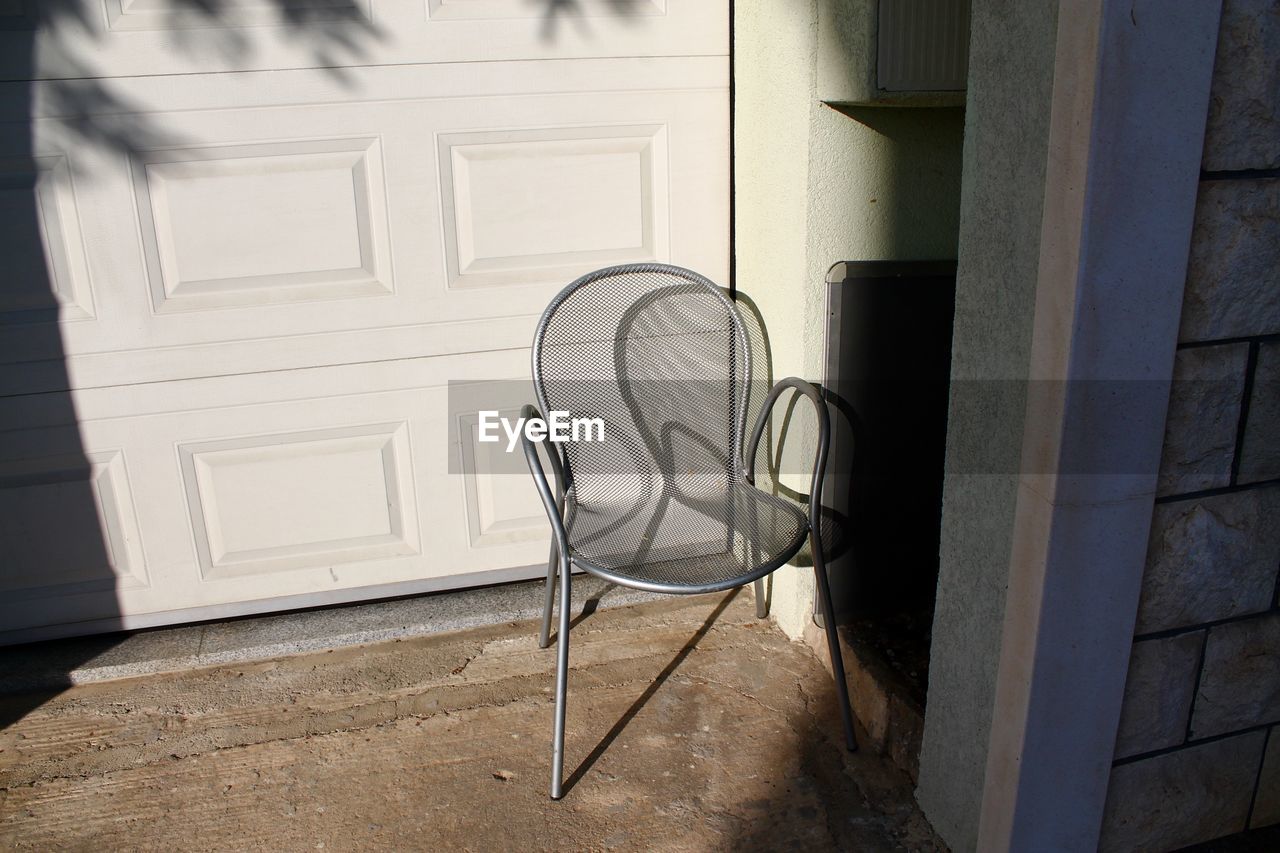 Empty chair outside building