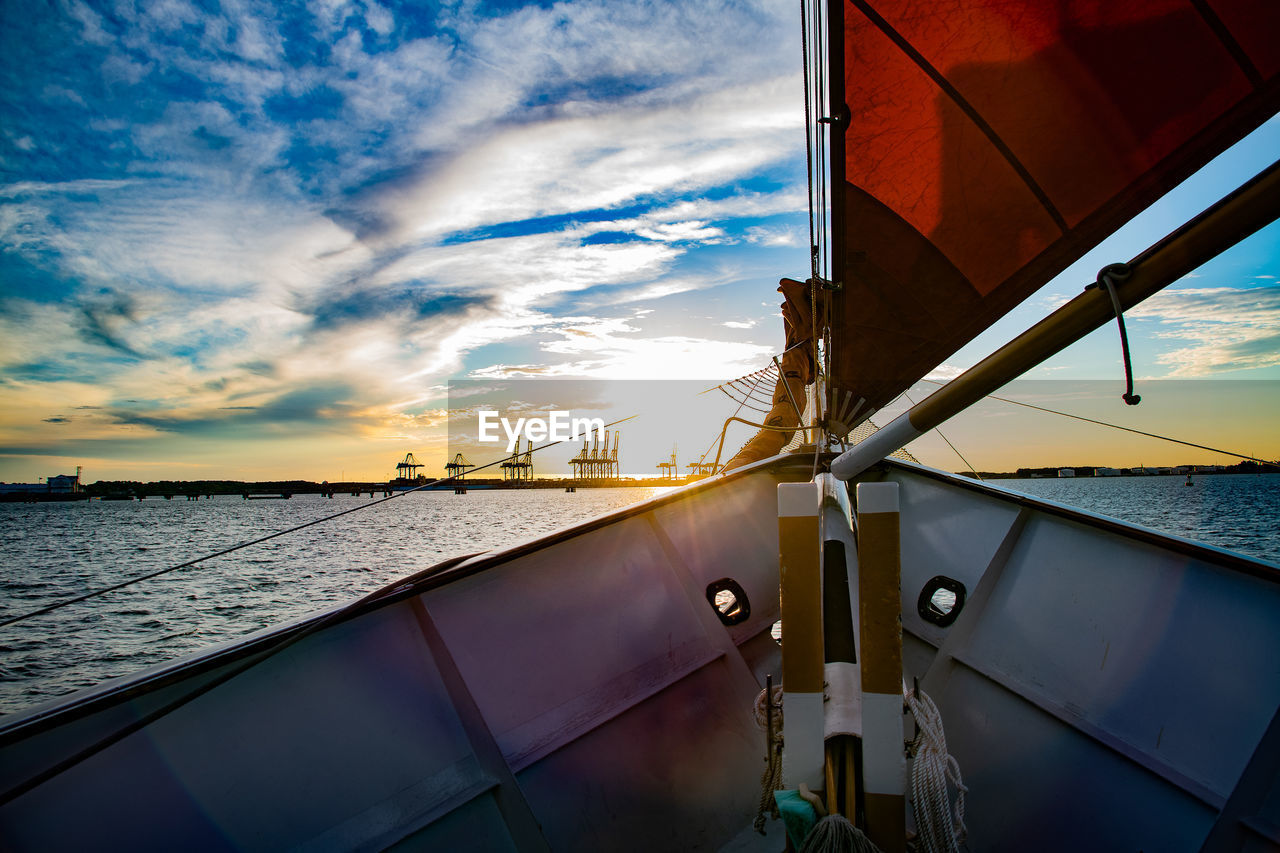 low angle view of boat on sea against sky during sunset