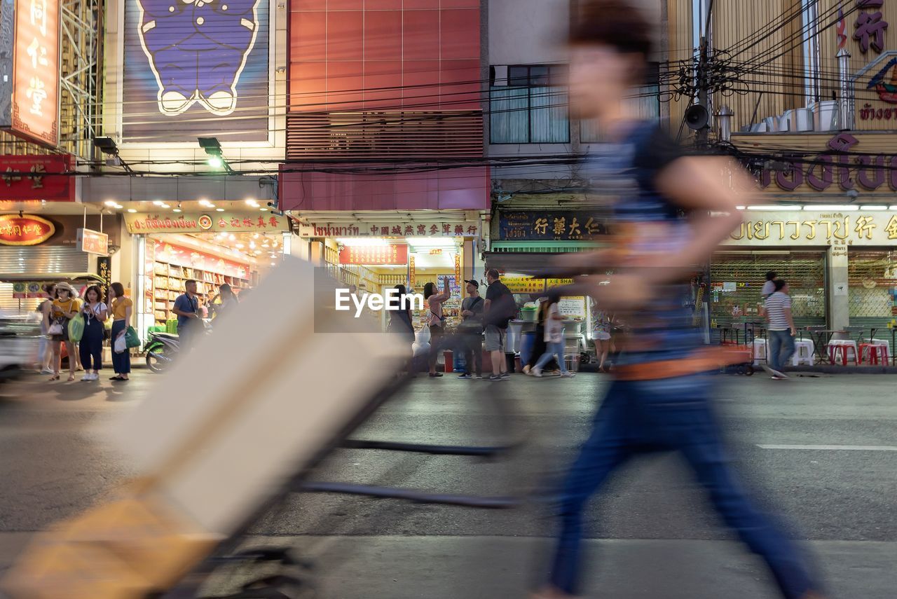 Blurred motionof delivery person in bangkok chinatown