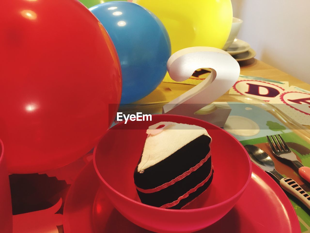 CLOSE-UP OF COLORFUL BALLOONS ON TABLE